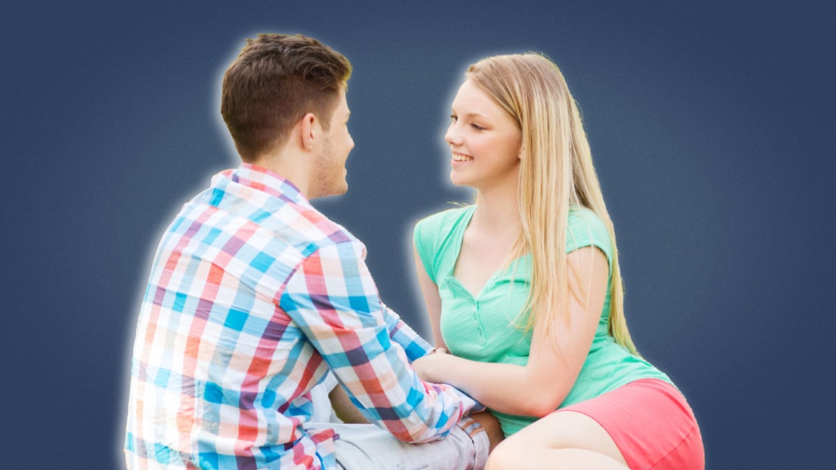 Questions-to-ask-a-girl-Young-couple-smiling-and-sitting-down-close
